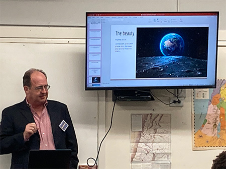 Photo of teacher presenting in classroom with students at the Science & Faith Workshop event