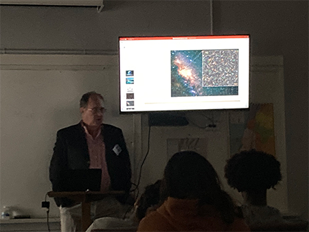 Photo of teacher presenting in classroom with students at the Science & Faith Workshop event