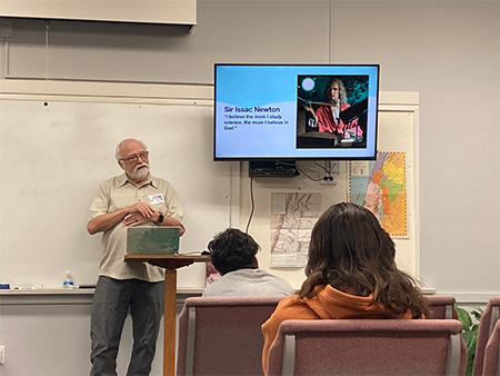 Photo of teacher presenting in classroom with students at the Science & Faith Workshop event